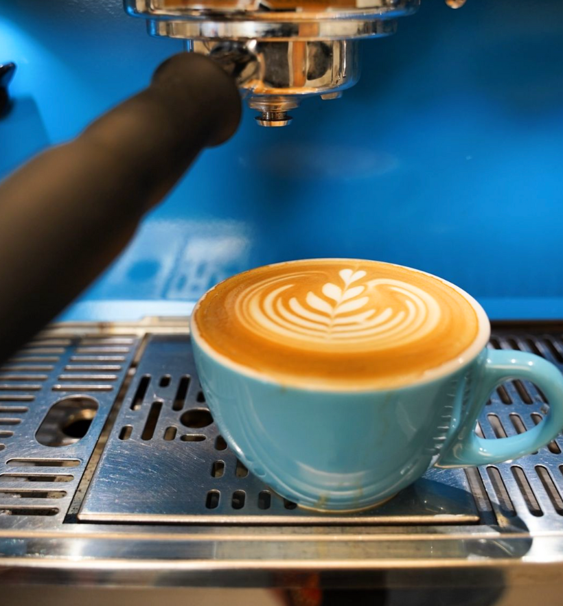 cappuccino coffee cup right below coffee machine